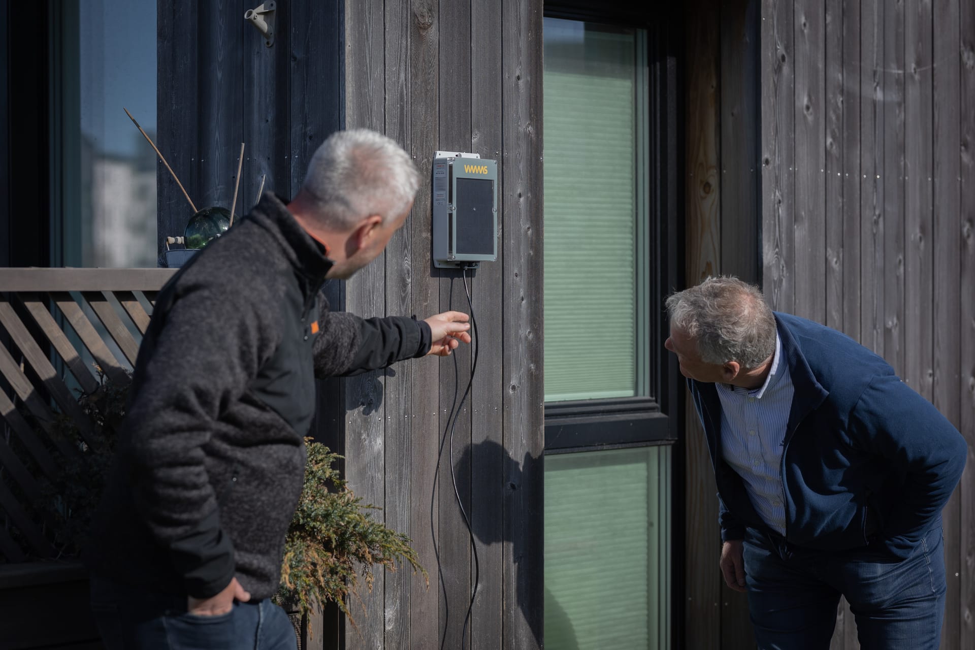 Demonstrating VIMMS Vibration Monitor installation on building wall