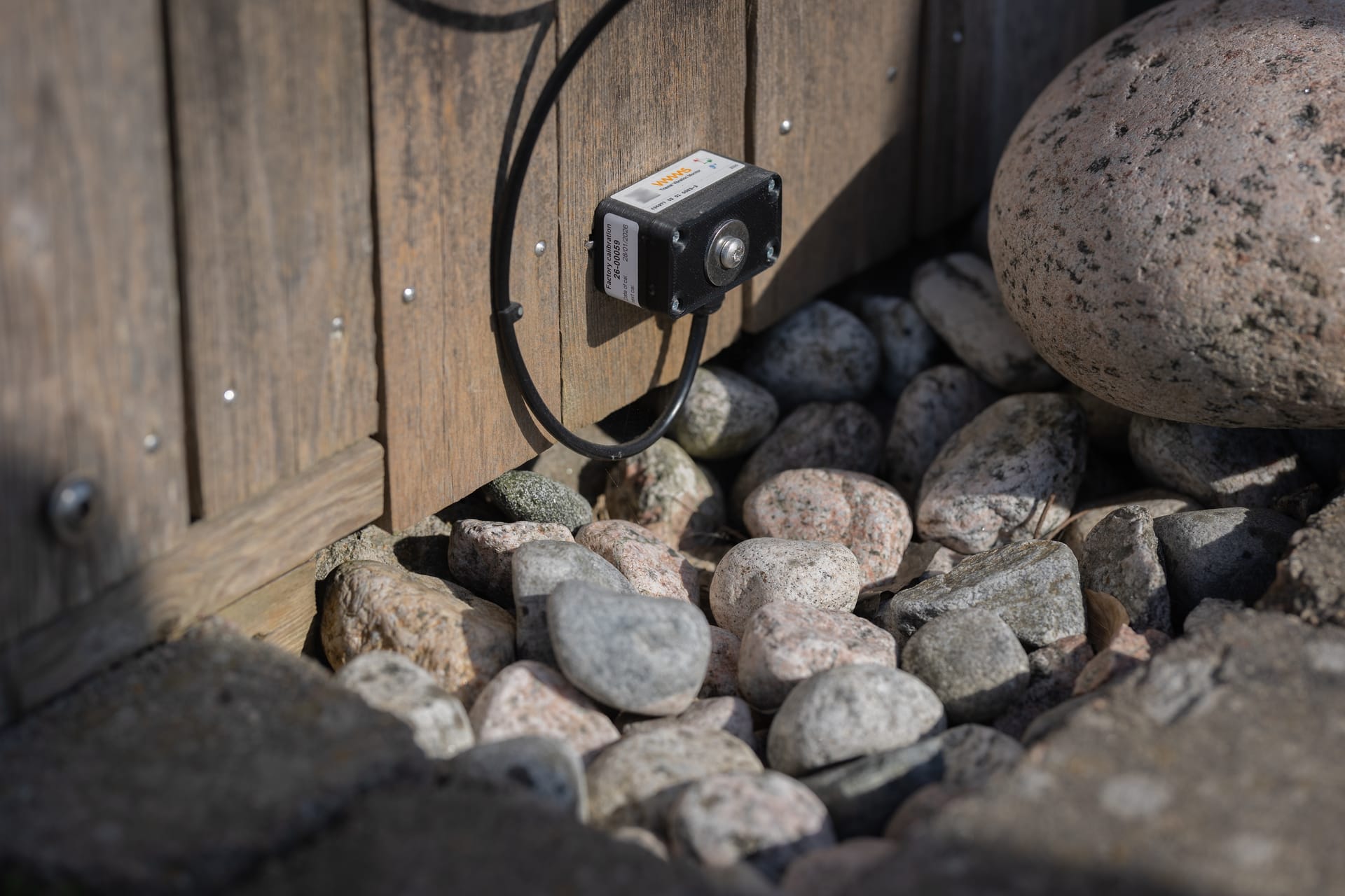 VIMMS geophone sensor installed at ground level among rocks